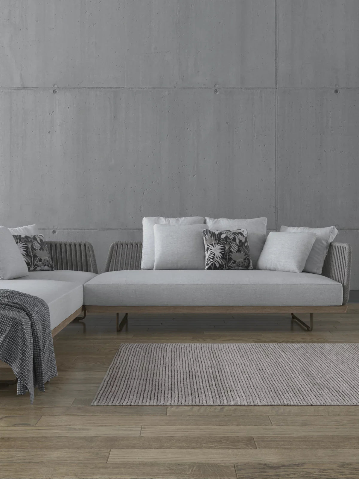 Modern minimalist living room with a textured 3x5 washable rug in neutral tones, placed on a wooden floor beneath a sleek sectional sofa.