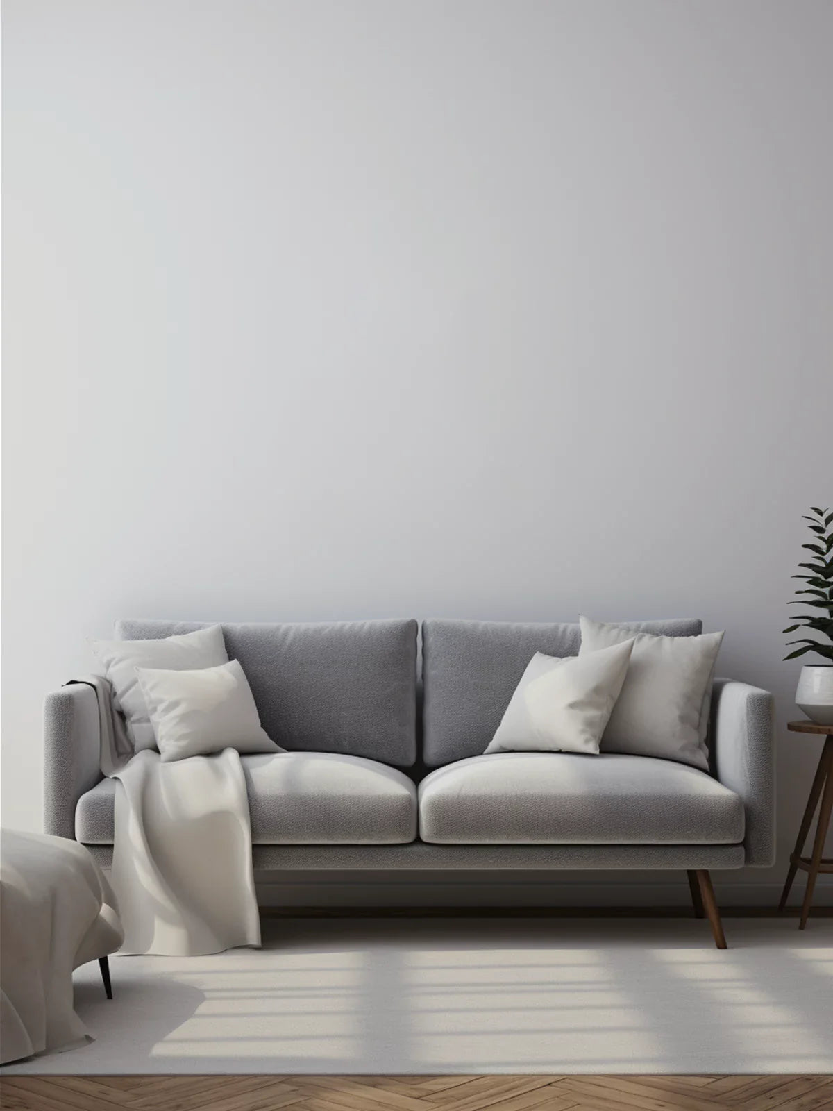 Neutral-toned 6x9 rug placed under a modern gray sofa with white throw pillows in a minimalist living room with soft natural lighting.
