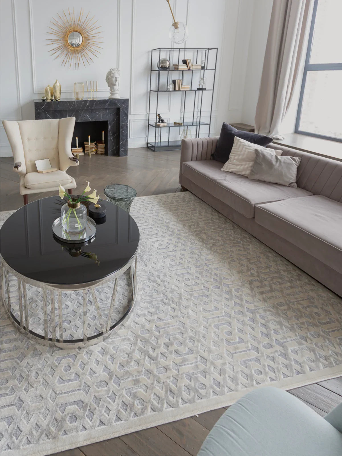 Elegant living room featuring a luxurious 9x12 washable rug with a geometric pattern, complemented by a velvet sofa, accent chair, and modern decor.