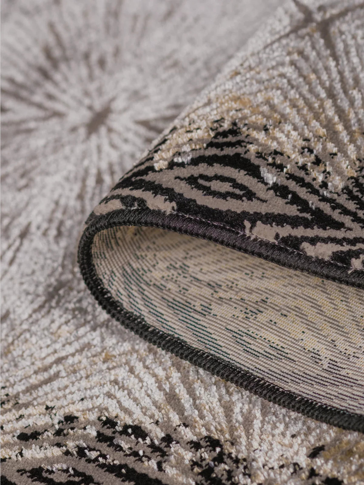 Close-up of a luxury rug showcasing intricate patterns, high-quality weaving, and a soft textured surface in elegant neutral tones.