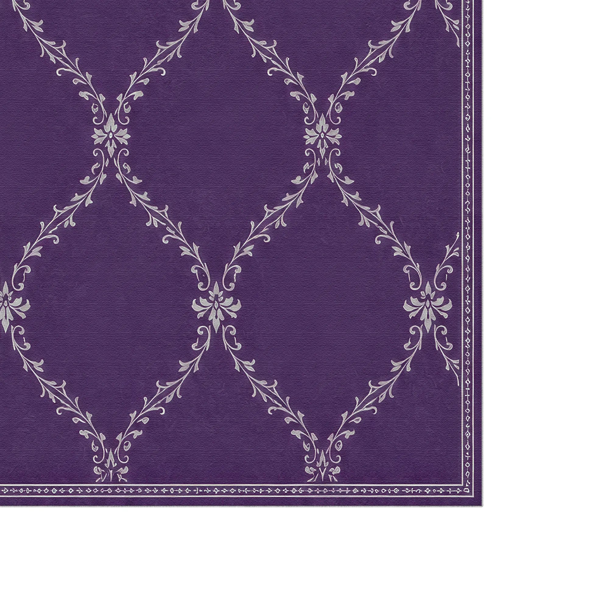 A close-up of a purple lattice rug or fabric with a repeating white damask-style floral pattern and a decorative border along the right and bottom edges.