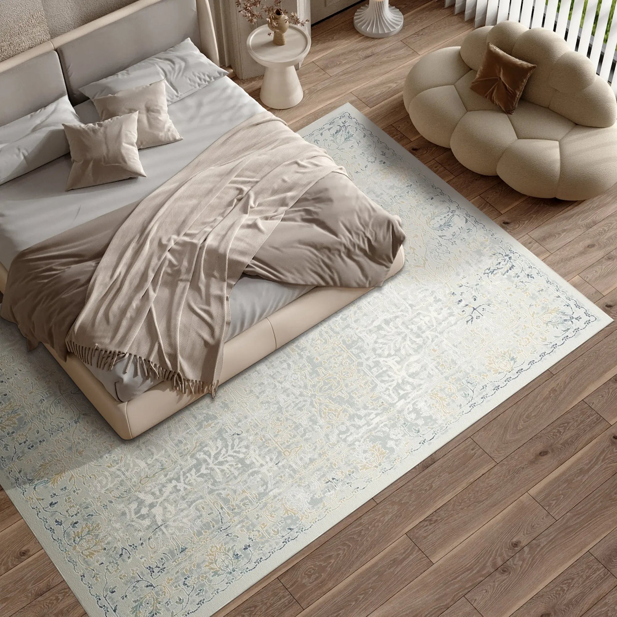 light blue area rug with faded floral and scroll patterns in bedroom setting