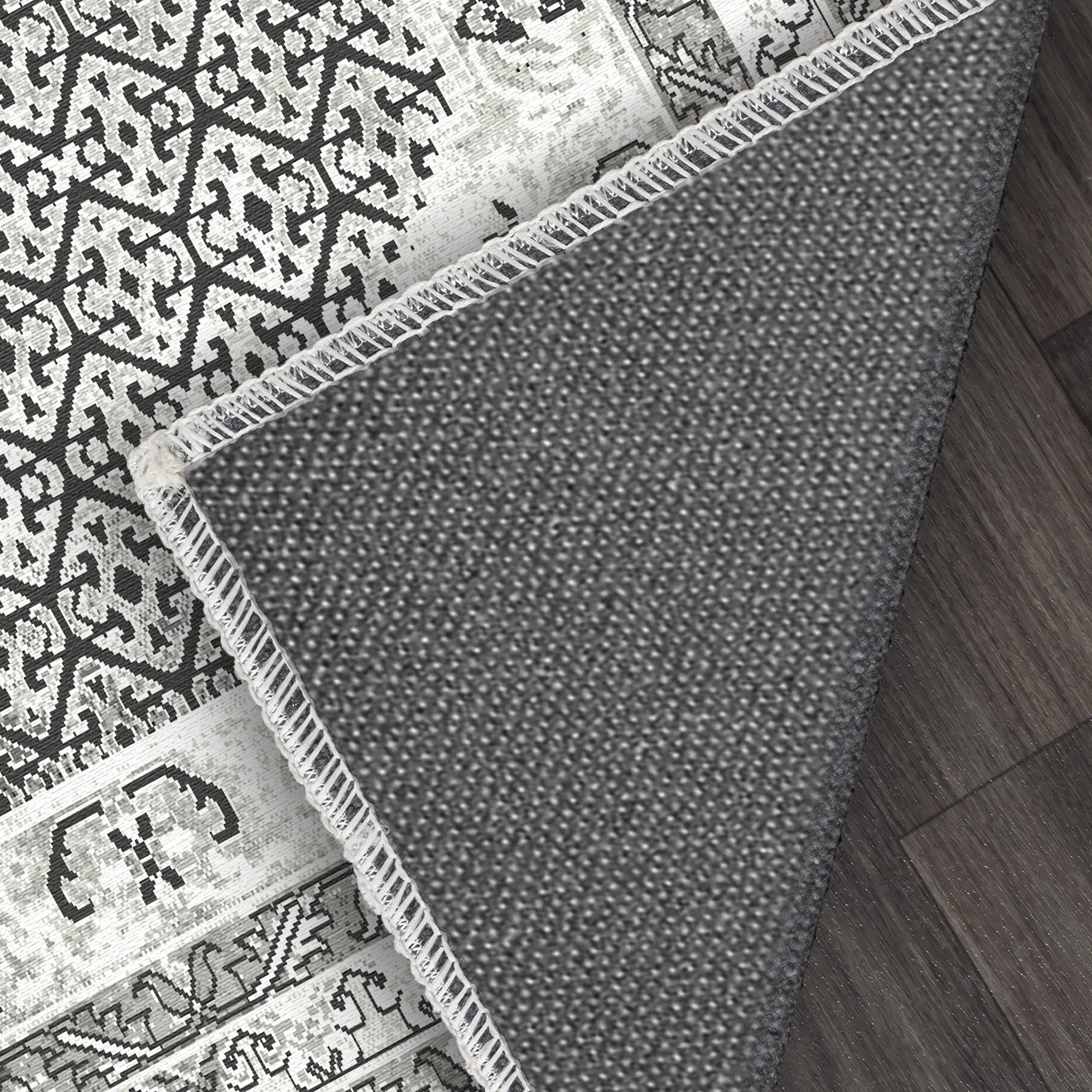 Gray patterned rug on a wooden floor