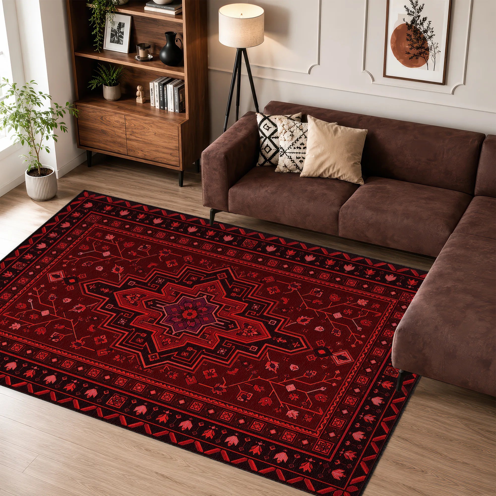 A large red and black patterned area rug with traditional geometric and floral motifs, shown in a styled living room next to a brown sectional sofa and wooden bookshelf.